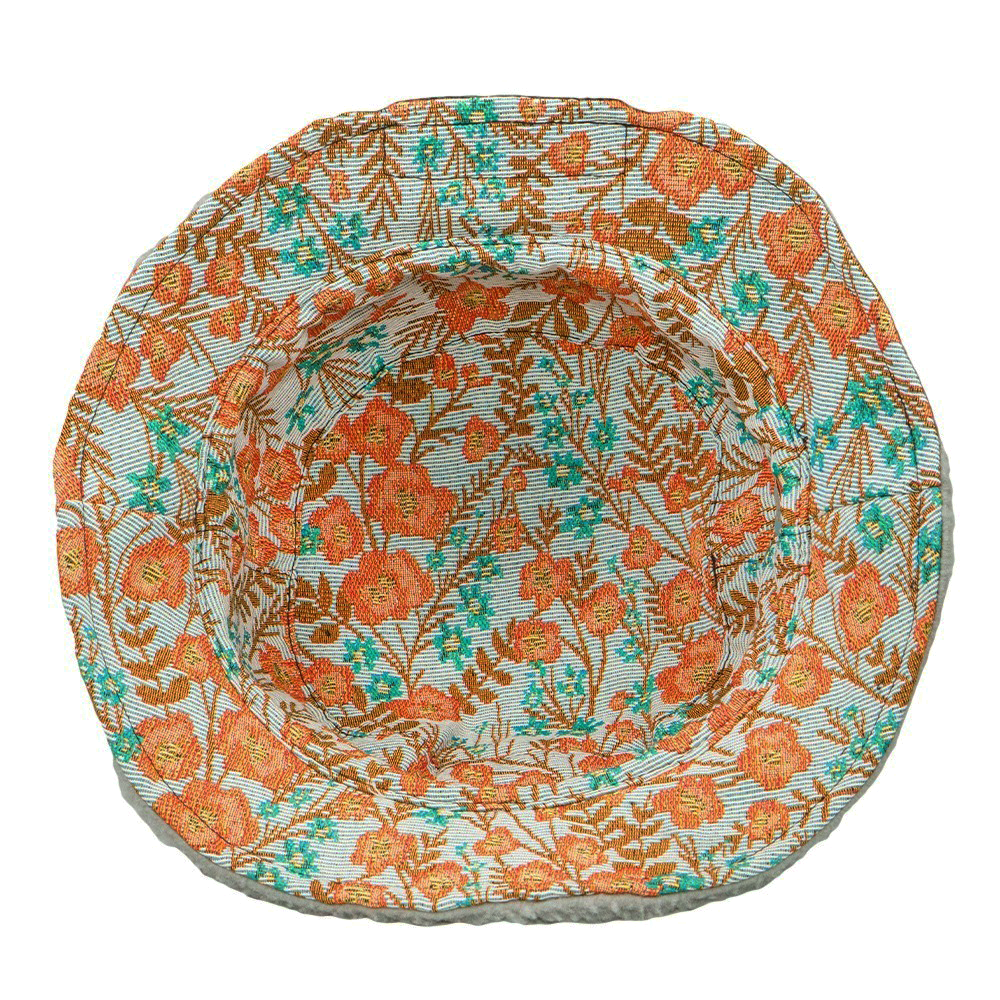 Reversible bucket hat with orange floral print and teal-green foliage pattern