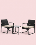 Studio view of 3-piece patio set: two dark woven chairs with cream cushions and square table