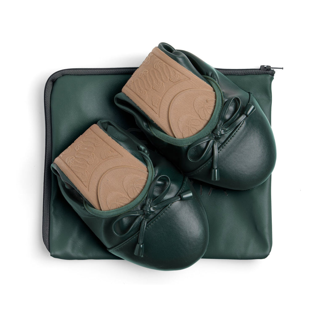 Pair of dark green leather flats with tan padded insoles in zip case