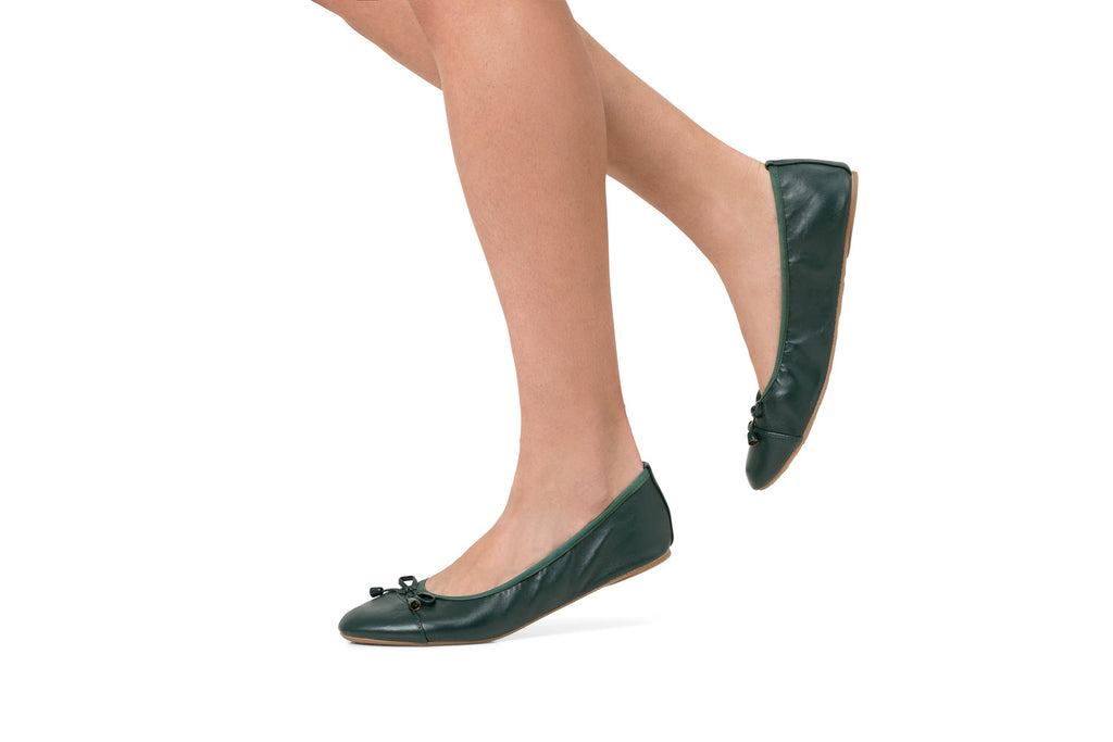 Dark green flats worn with bow-tie closure and rounded toe