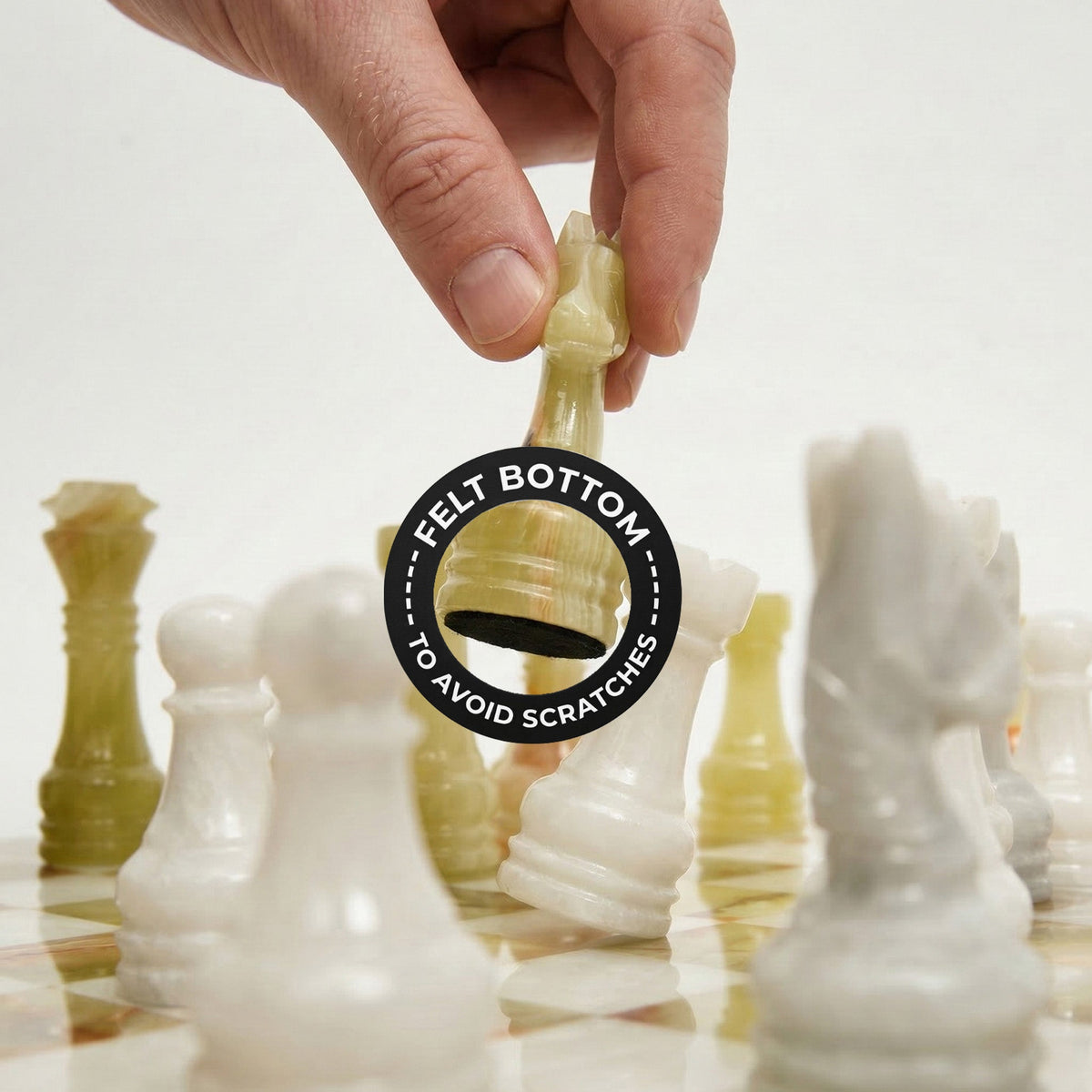 Gold chess piece held above board; felt bottom label indicates scratch-resistant felt base
