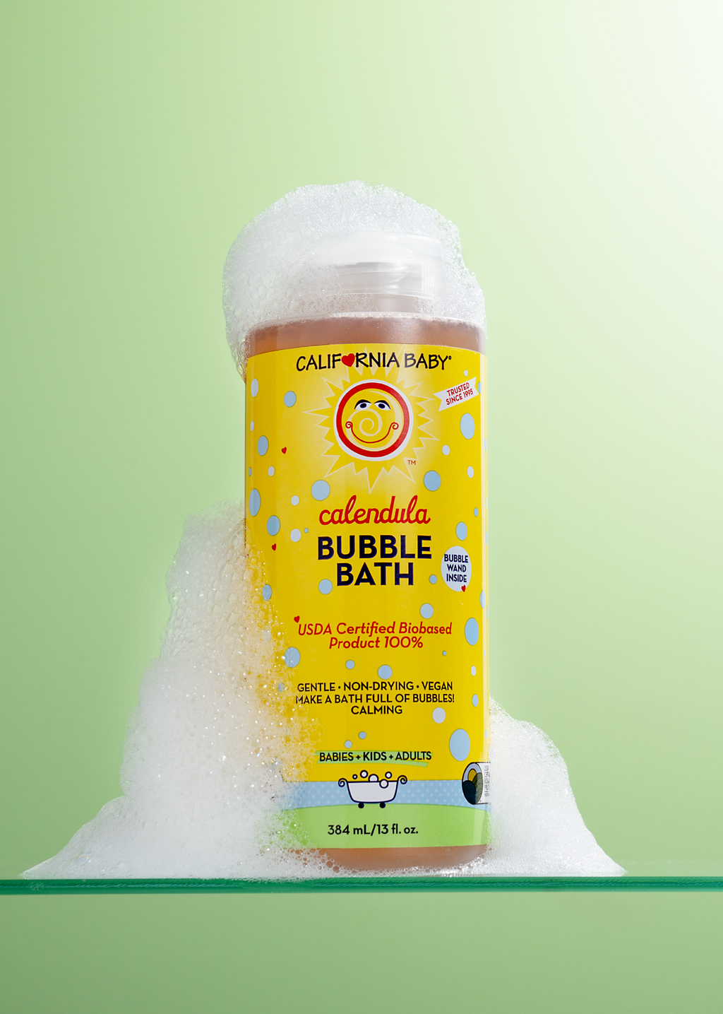 Calendula bubble bath bottle with bubbles piled up around the label