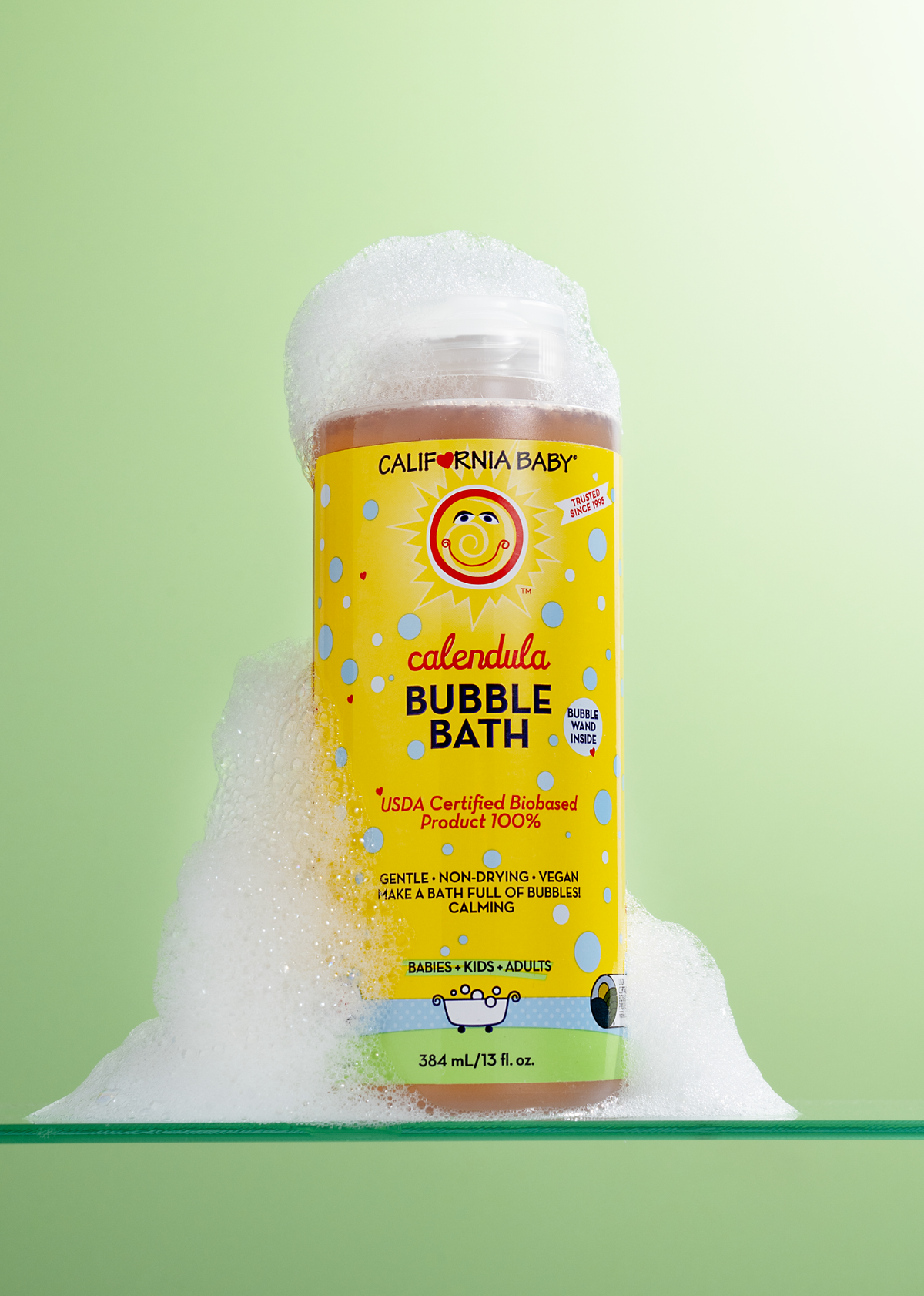 Calendula bubble bath bottle with bubbles piled up around the label