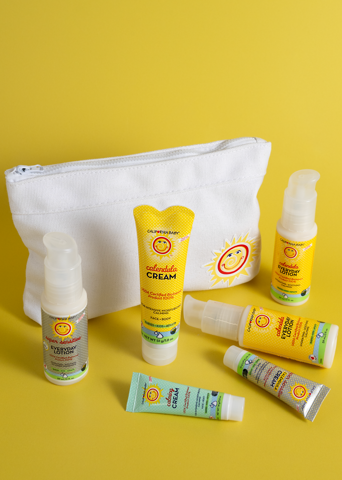 White zippered travel pouch with sun-face patch and top zipper