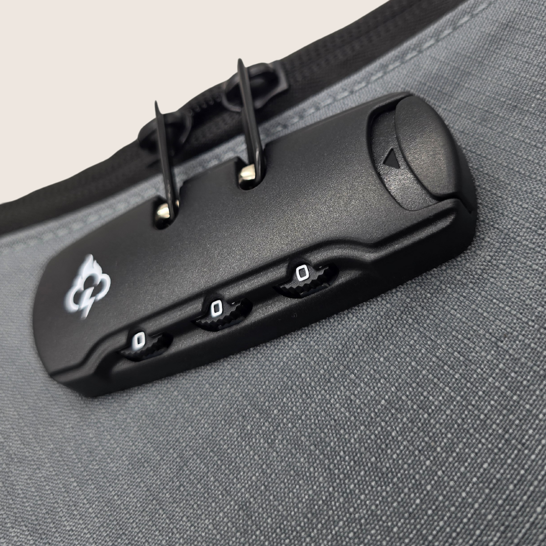 Close-up of gray bag's black hidden lock panel with combo knobs