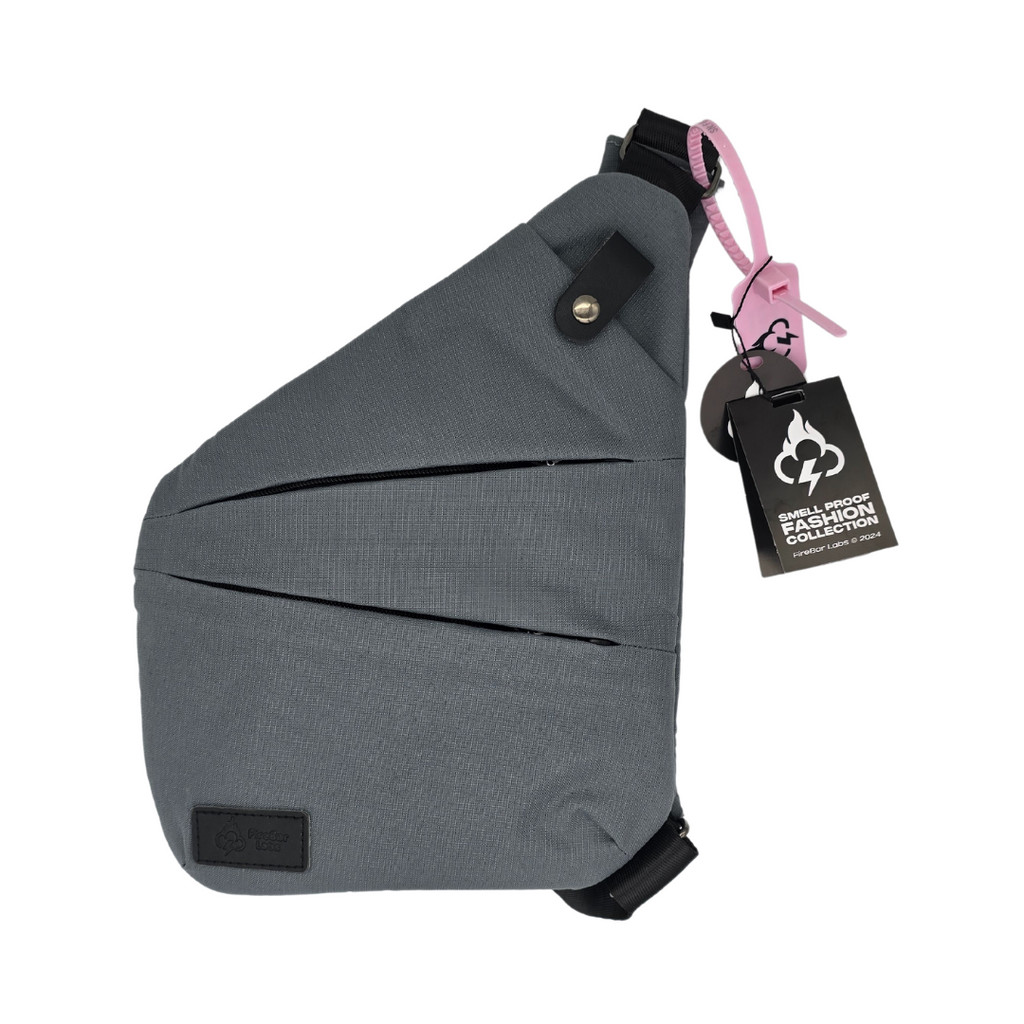 Gray crossbody bag with top flap and pink-lined zipper pull