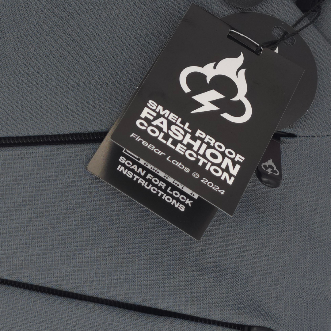 Smell-proof style hang tag on gray crossbody bag