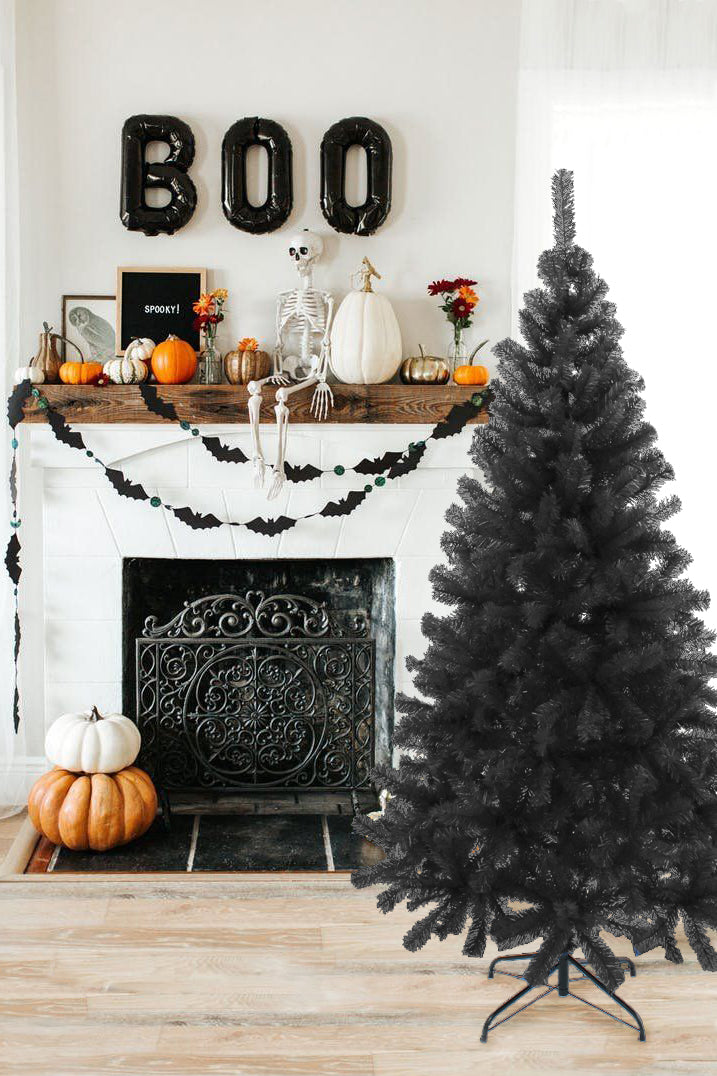 Black artificial pine Christmas tree on metal stand