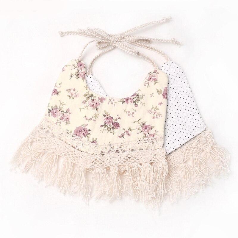 Cream floral and polka double-layer baby bib with tassel fringe and pom trim ties
