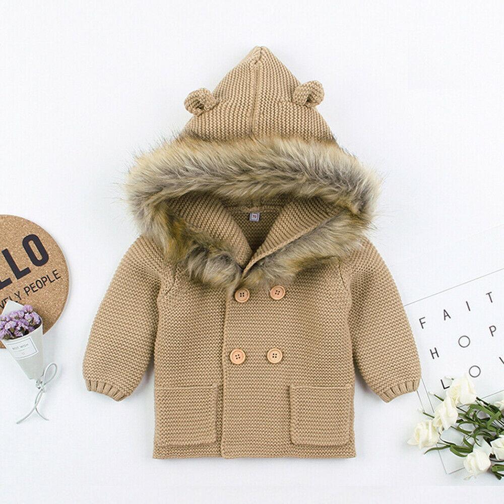 Beige knit newborn hooded coat with brown faux-fur trim and four-button front