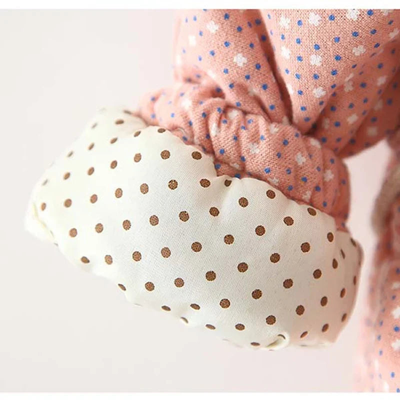 Close-up of pink floral hooded jacket fabric with gathered ruffle and stitching details
