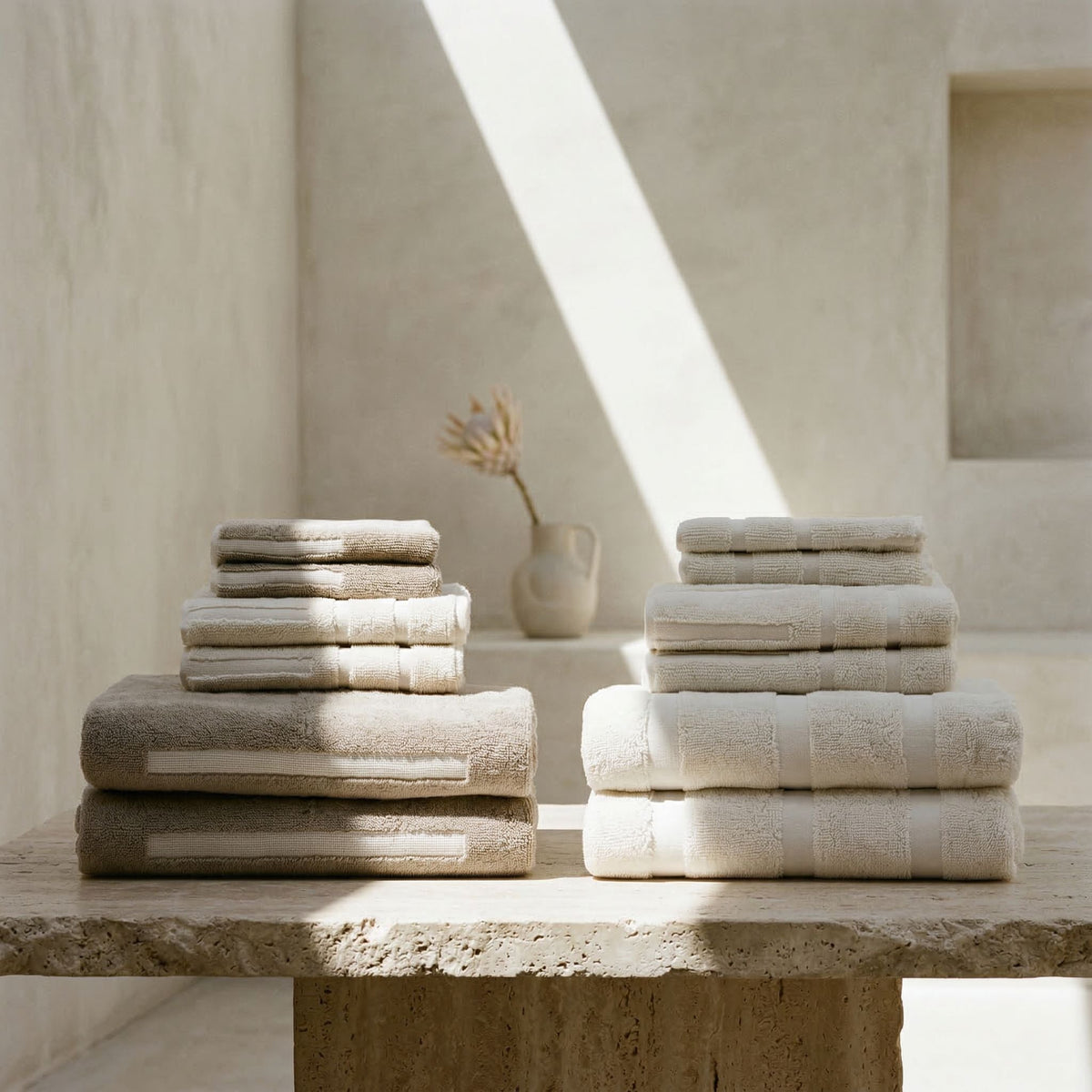 Ecru cotton towel set with stacked washcloths and towels in coordinating tones