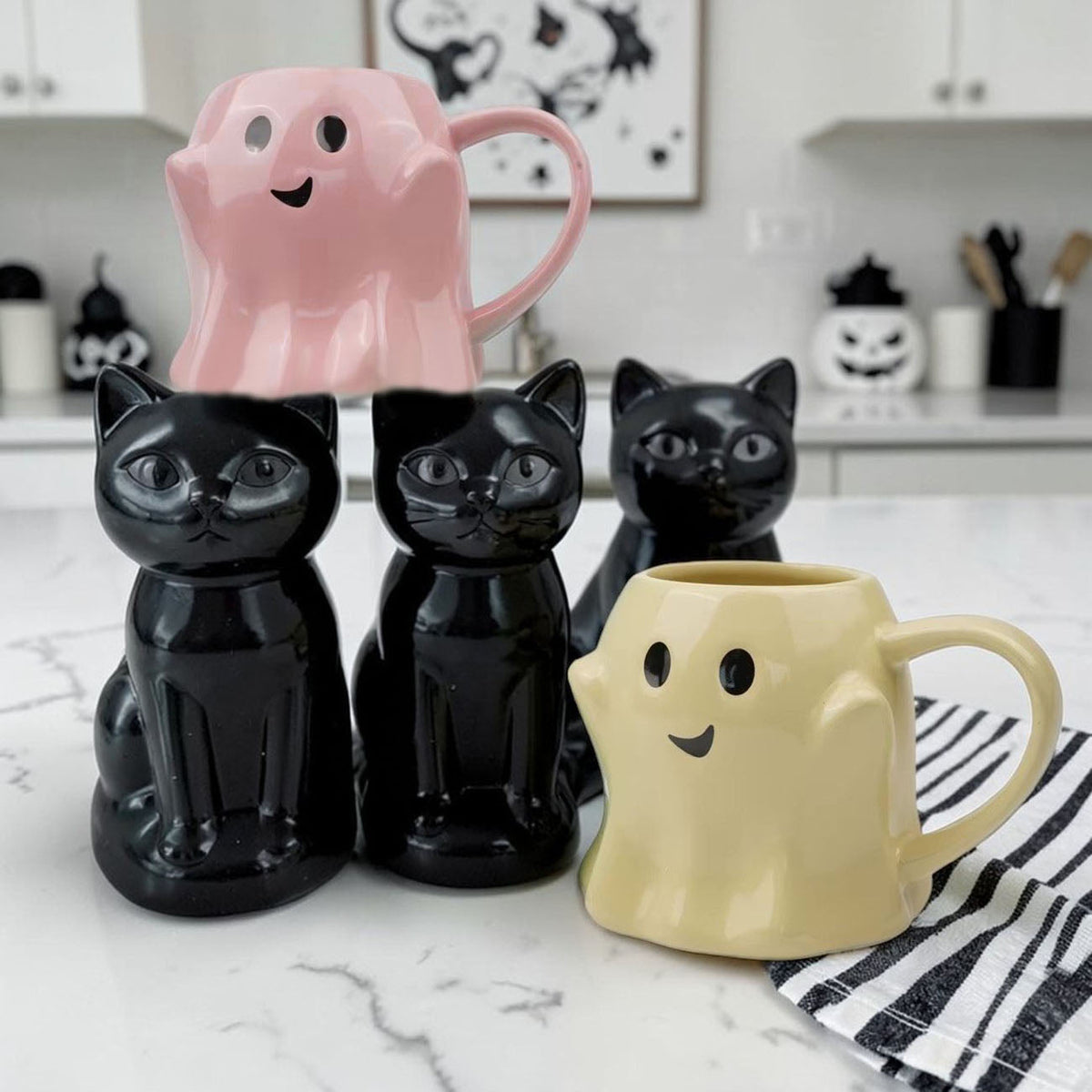 Pink ghost-shaped ceramic mug with smiling face and rounded handle