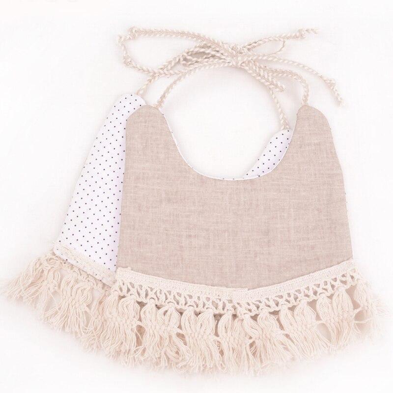 Beige and purple polka-dot double bib set with fringe trim and braided ties.