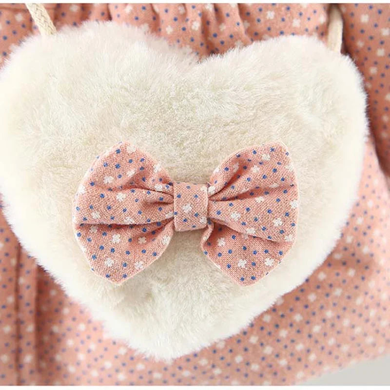 Heart-shaped plush crossbody pocket on pink floral hooded jacket with bow detail