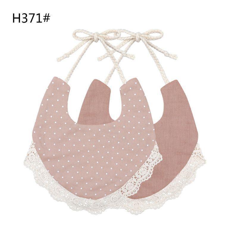Infant bib set in dusty pink with polka-dot fabric, lace trim, and string ties