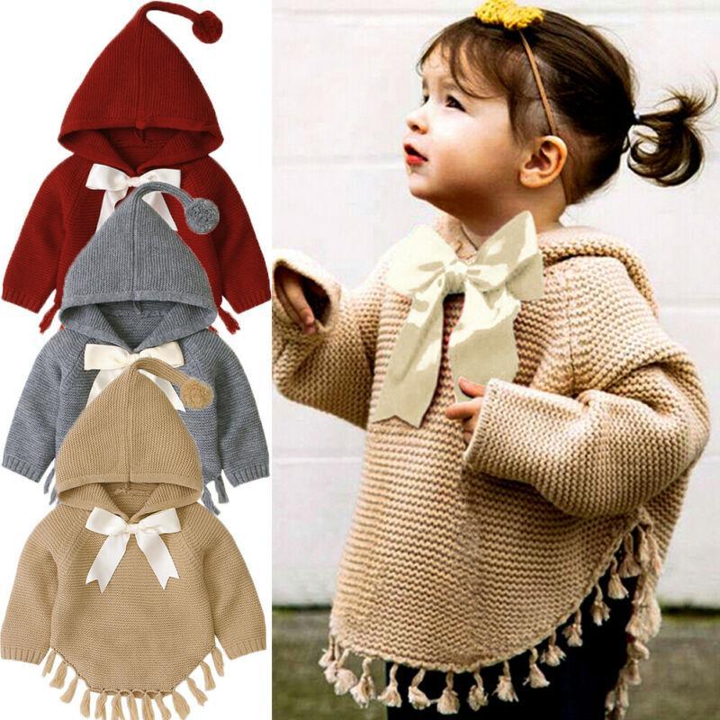 Knitted hooded toddler pullover with large white bow and tassel-trim hem in red/gray/khaki