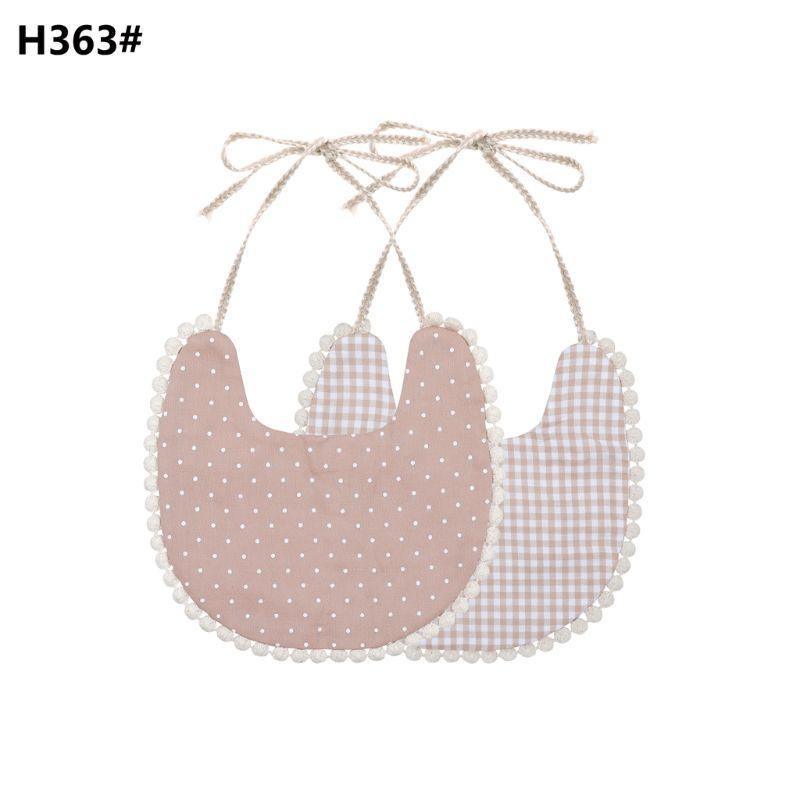 Double-sided cotton baby bib with tassel ties; mauve polka dots and gingham plaid.