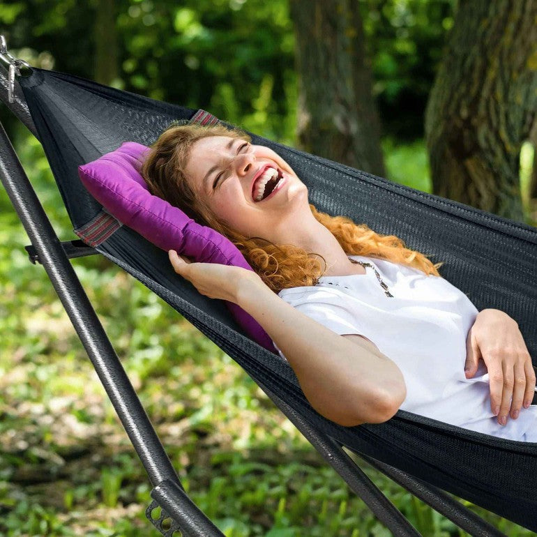 Black hammock on metal stand with woven fabric and striped border edge