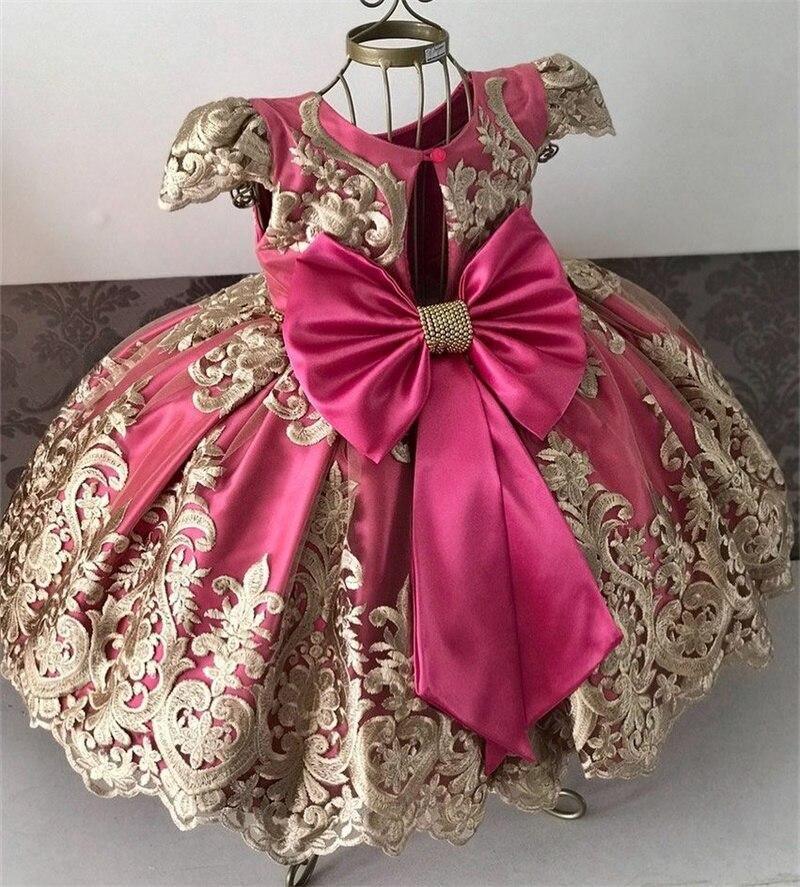 Baby girl princess tutu dress in fuchsia satin with ornate gold lace skirt and big bow