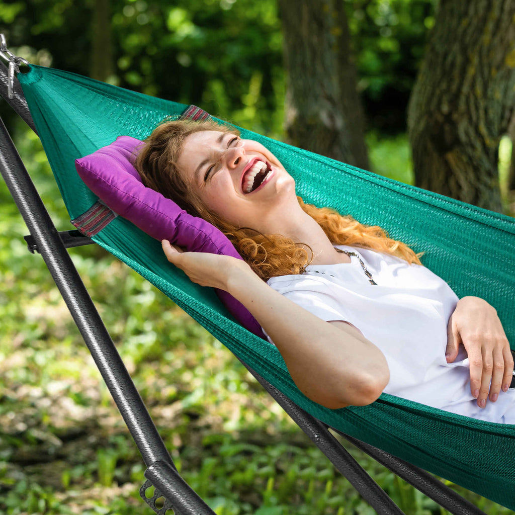 Outdoor hammock with dark steel stand and green fabric