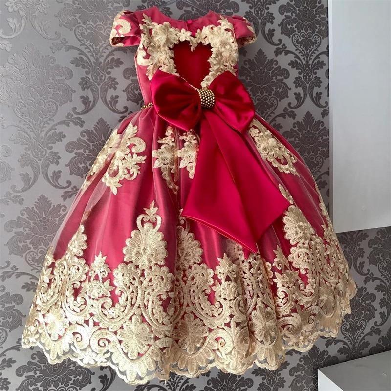 Baby girl princess tutu dress in deep pink satin with oversized bow and gold lace trim