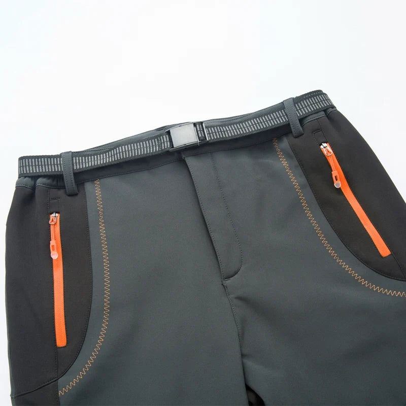 Men's waterproof hiking pants, black with orange zipper detail and side pocket