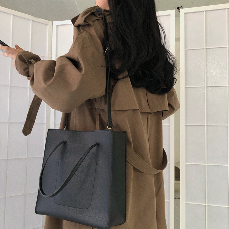 Brown double-breasted long overcoat with wide sleeves and tied belt