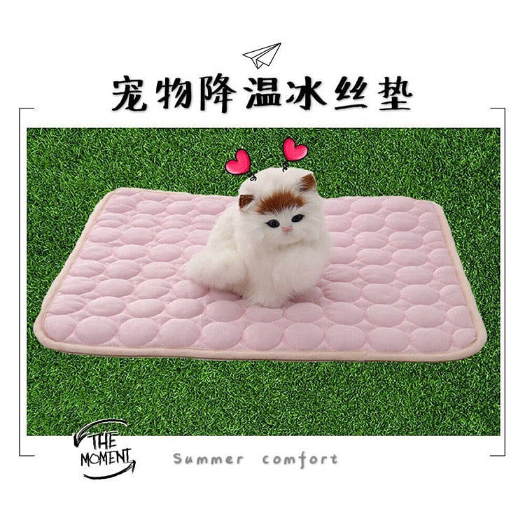 Pink dog cool pad cushion mat with quilted bubble pattern on grass