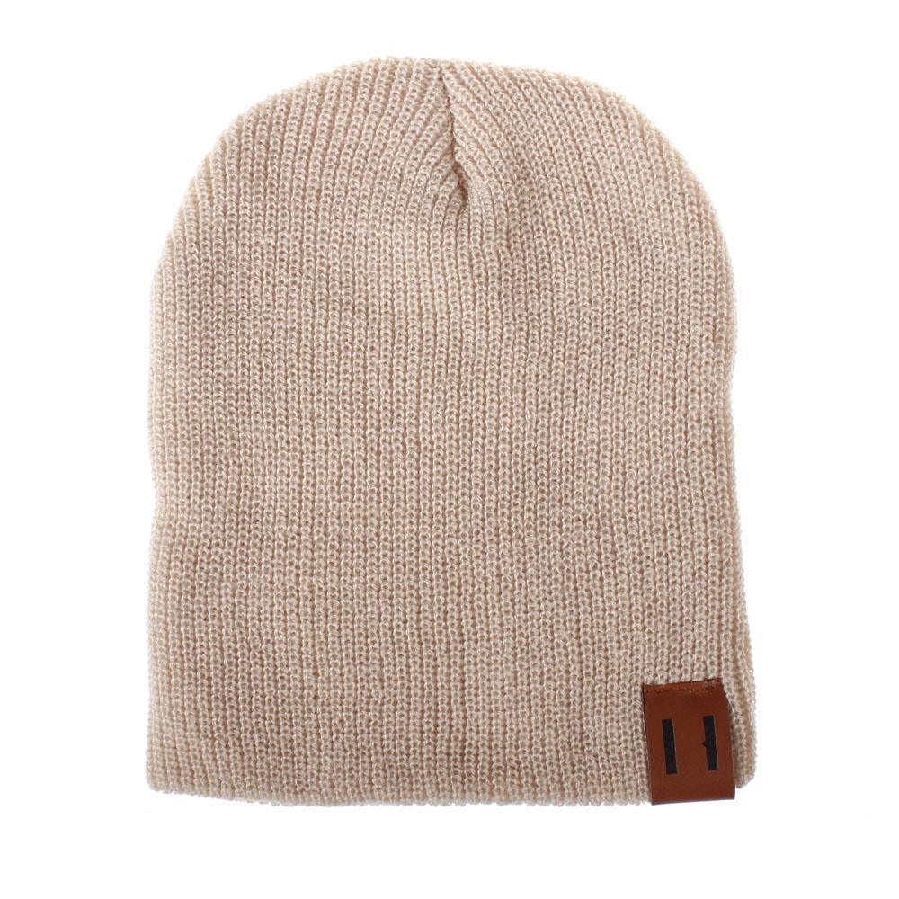 Tan knit beanie hat with foldover cuff and brown logo patch