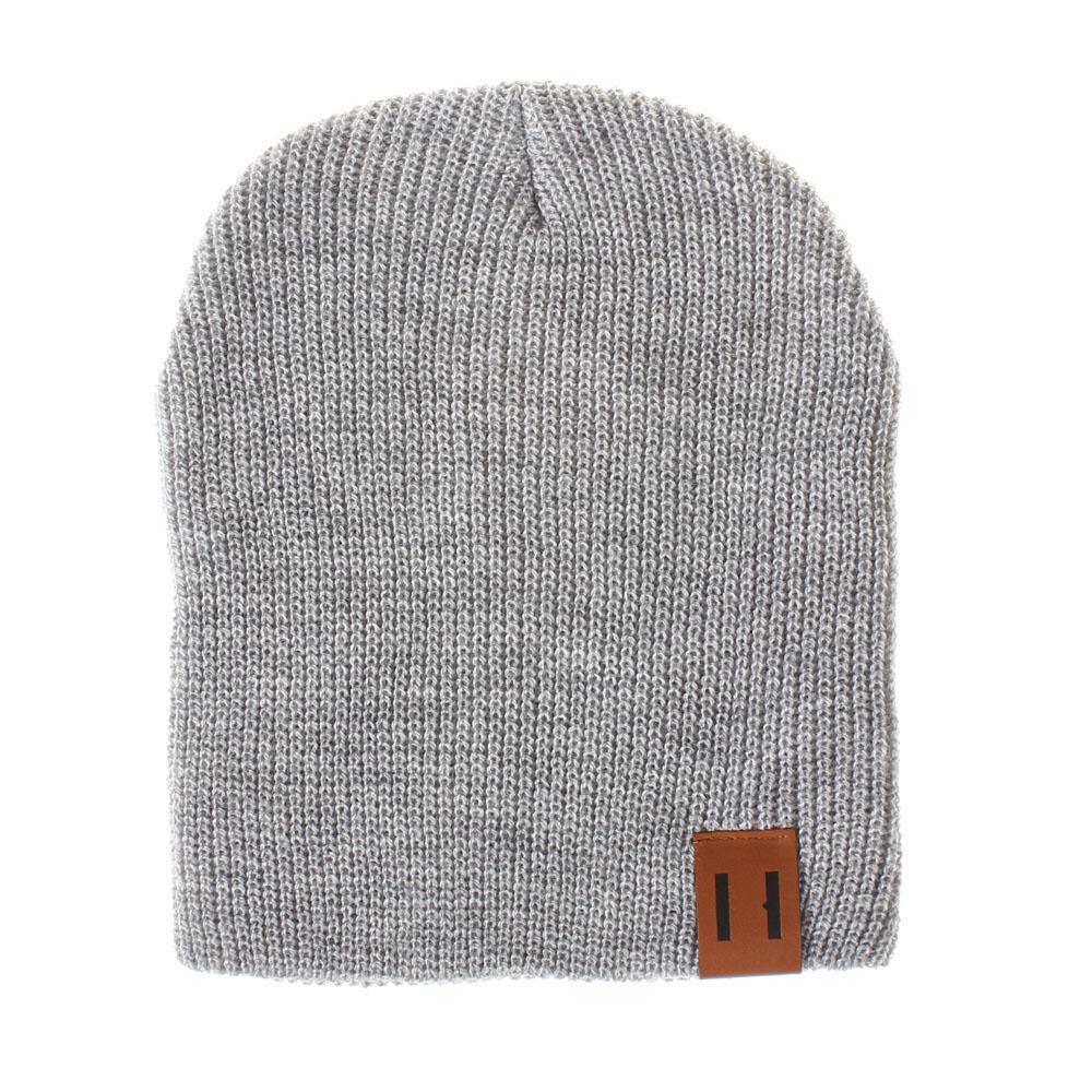 Light gray knit beanie hat with foldover cuff and brown logo patch