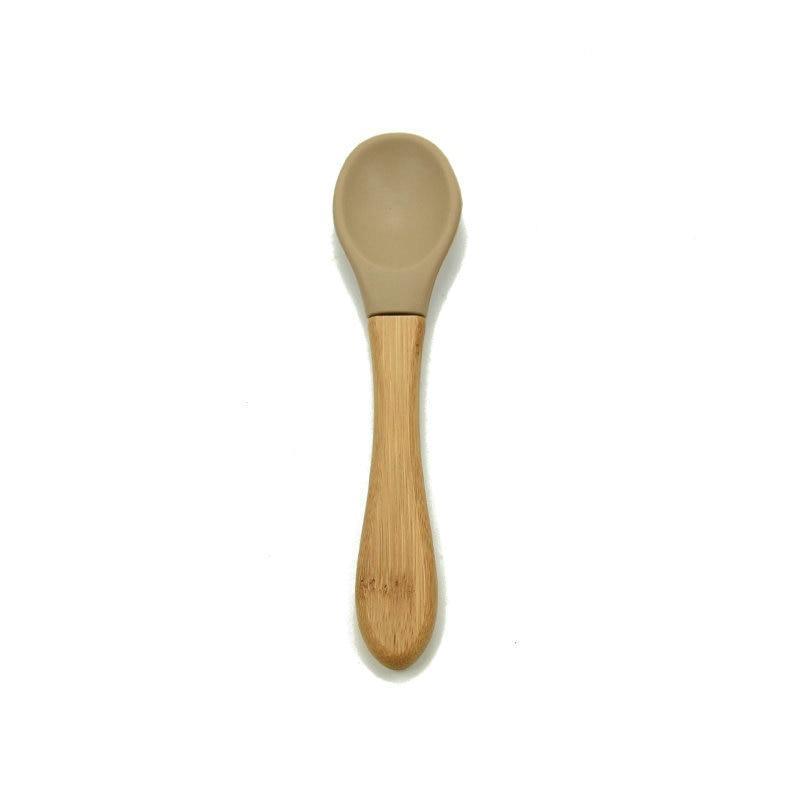 Baby feeding spoon with wooden handle and tan silicone tip for toddlers