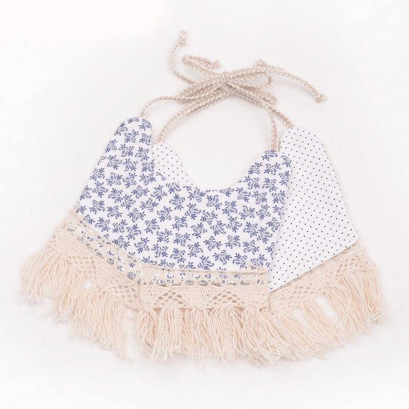 Blue and white double-layer baby bib with tassel fringe, pom trim, and tied neck
