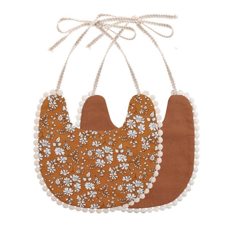 Infant double-sided bib with tassel ties, brown floral front and solid brown reverse
