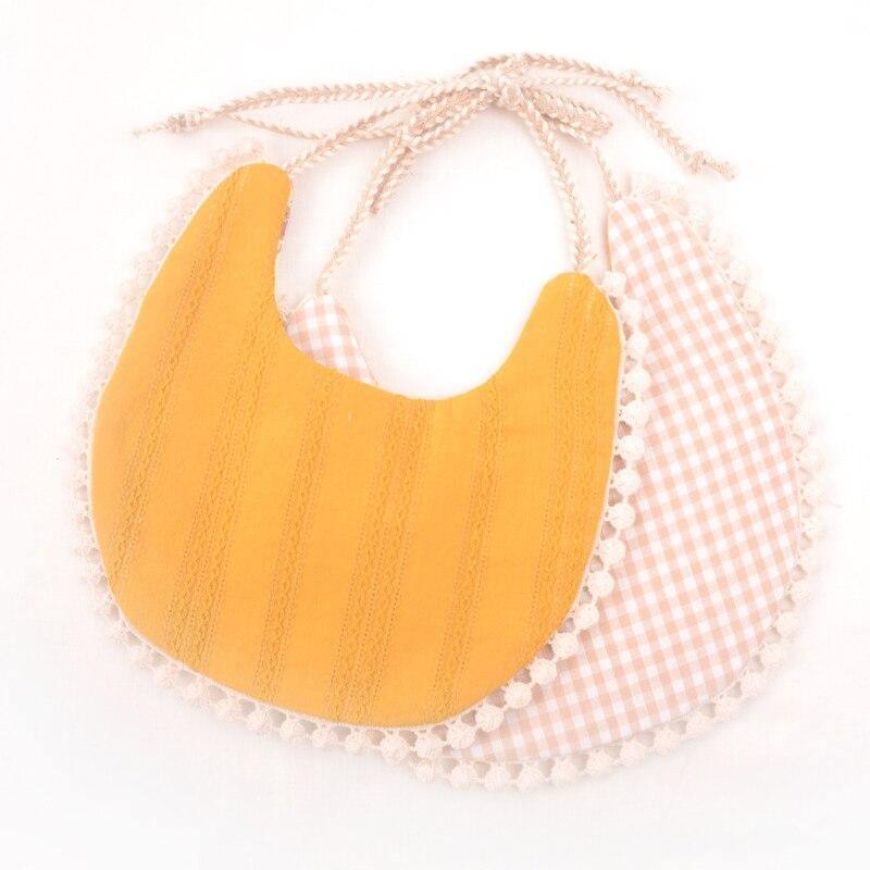 Orange and checkered double bib set with tassel trim and braided ties.