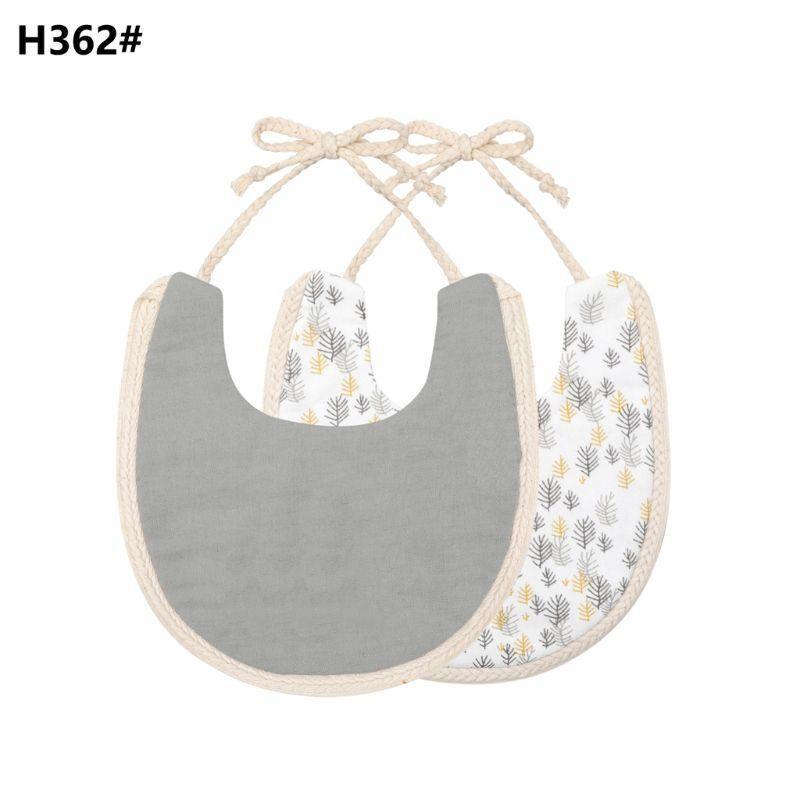 Double-sided cotton baby bib with tassel ties; gray solid and leaf print.
