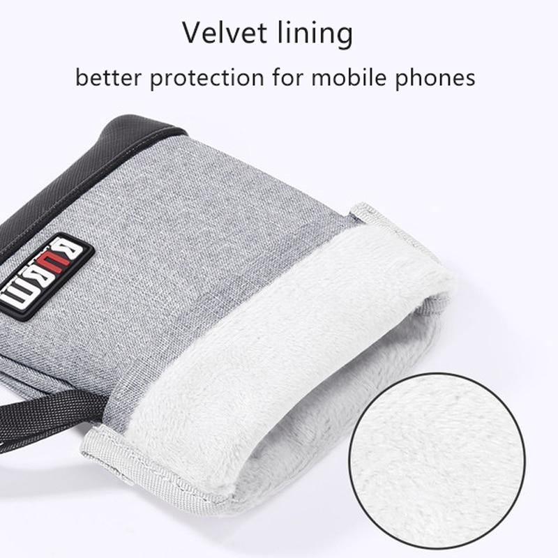 Grey phone pouch with soft lining, flap closure, and adjustable side strap loop
