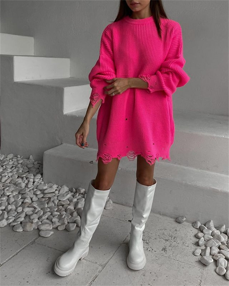 Pink oversized mini sweater dress, ribbed knit, round neckline, long sleeves, frayed hem