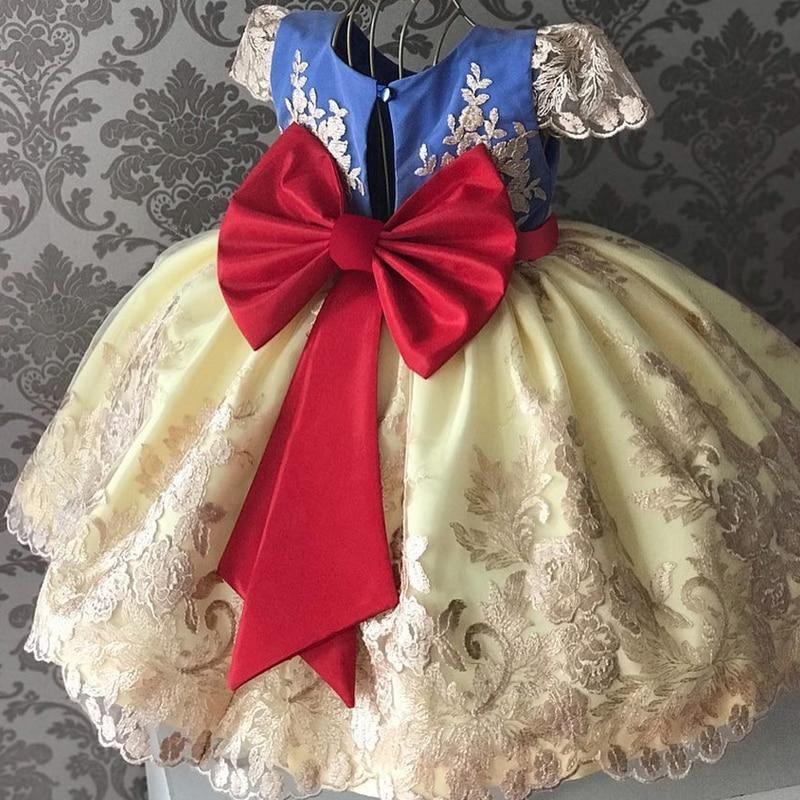 Baby girl princess tutu dress in pale yellow satin with red bow and white lace trim