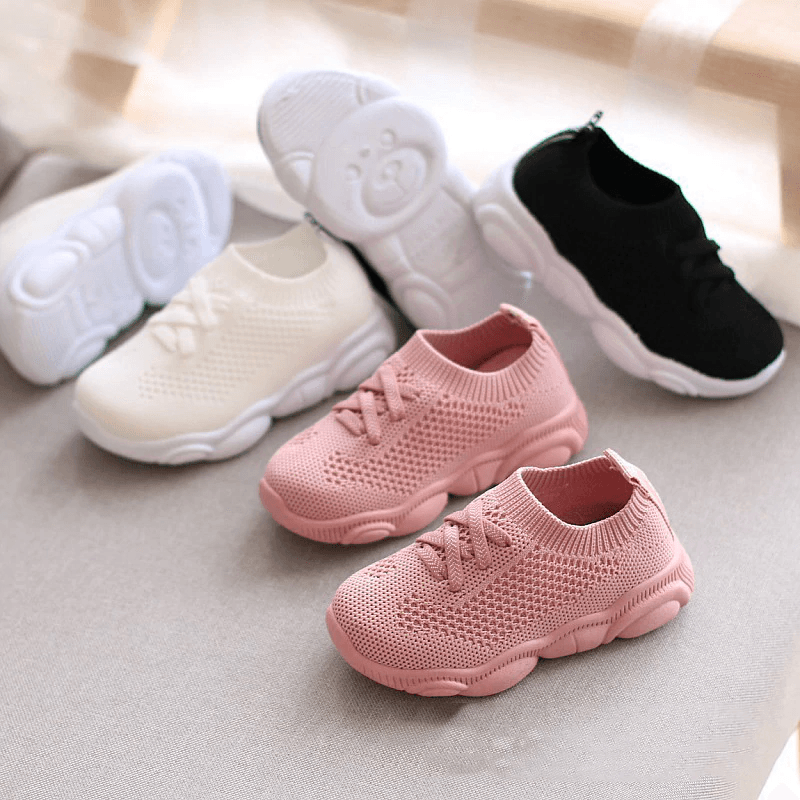Pink knit baby sneakers, lace-up style with cushioned soft soles
