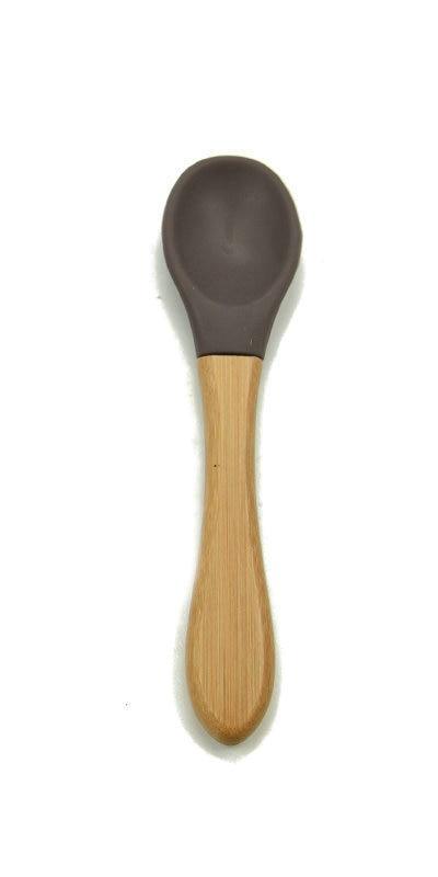 Baby feeding spoon with wooden handle and dark brown silicone tip