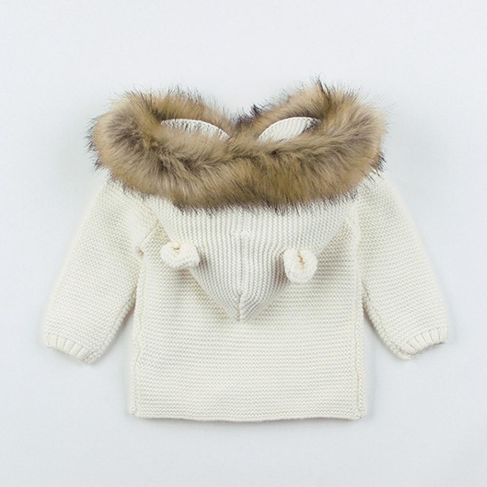 Newborn knitted hooded jacket, white with tan faux-fur trim and button details