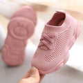 Pink knit baby sneakers with lace-up front and white flexible sole