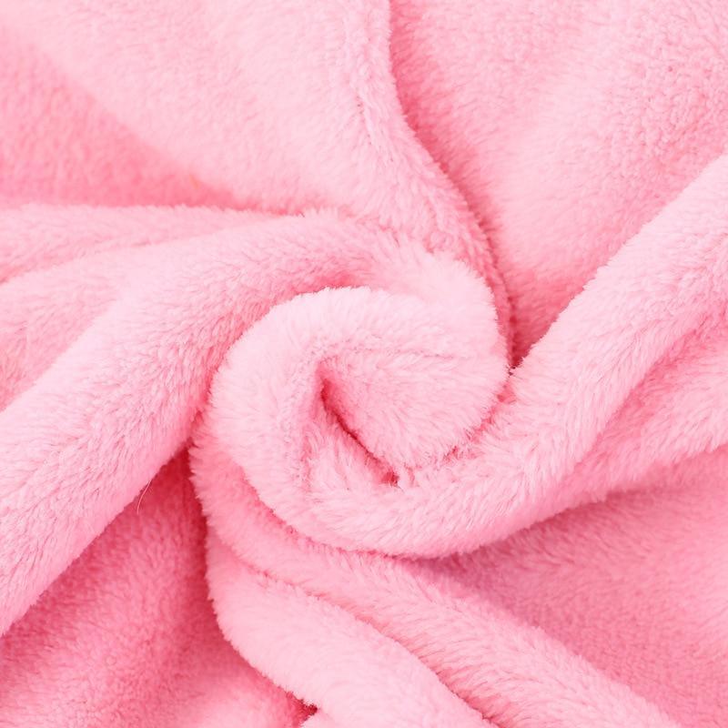 Pink plush fabric close-up for a soft hooded baby romper