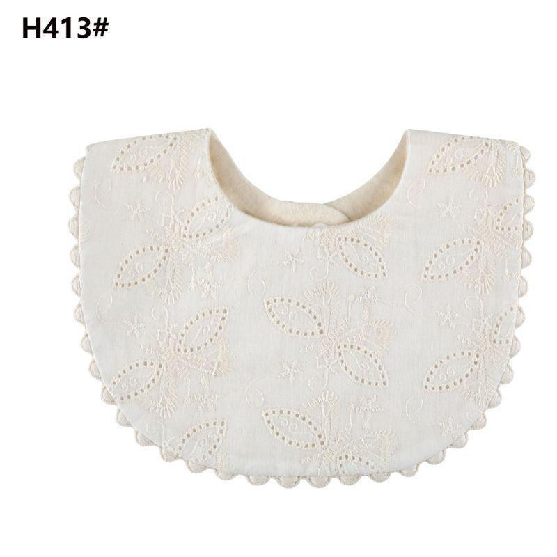 Infant double-sided bib with tassel ties, white eyelet front and patterned olive reverse
