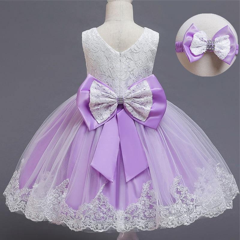 Lavender tulle dress with lace bodice and large purple satin bow at waist