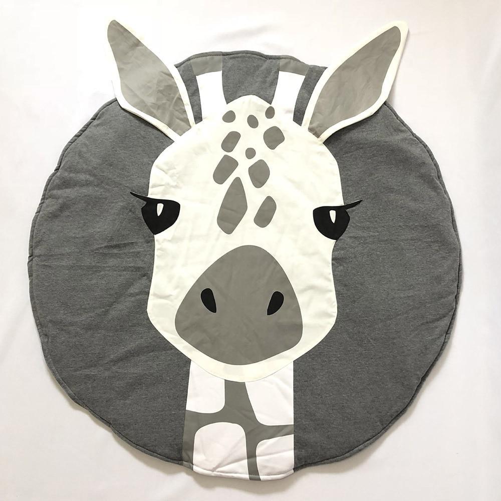 Round animal baby play mat in gray and white with giraffe face applique.
