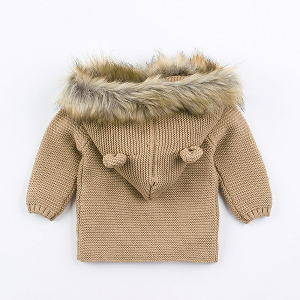 Newborn knitted hooded jacket, beige with tan faux-fur trim and tied hood accents
