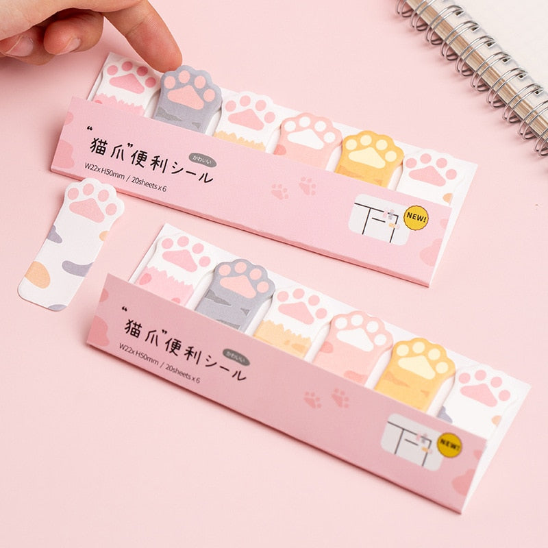 Cat paw sticky note set with multiple pastel note tabs in pink, gray, and yellow designs