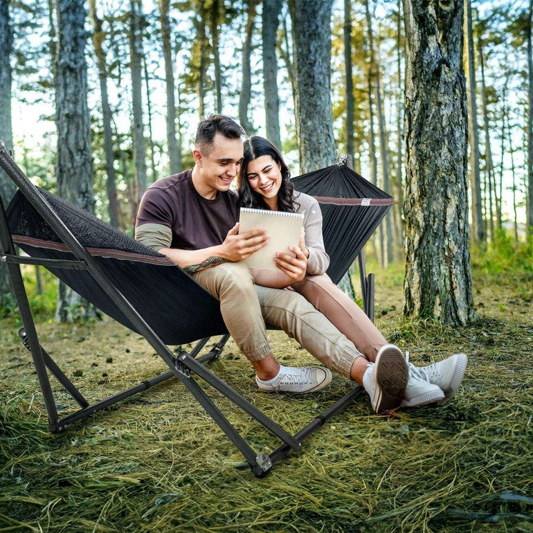 Black hammock on metal stand with curved sling fabric and stable base
